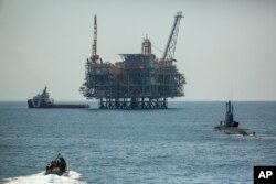 An oil platform in Israel's offshore Leviathan gas field is seen from on board the Israeli Navy Ship Atzmaut as a submarine patrols, in the Mediterranean Sea, Wednesday, Sept. 1, 2021.(AP Photo/Ariel Schalit)