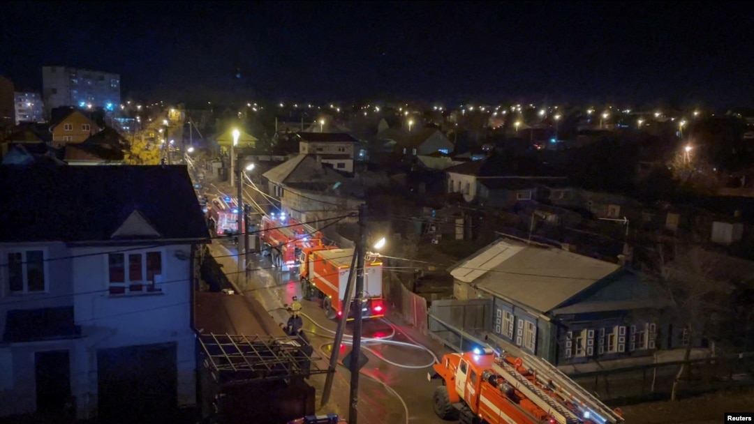 Firefighters work at a site of a plane crash into residential building in the city of Irkutsk, Russia, Oct. 23, 2022, in this still picture taken from a video. 