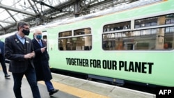 FILE - Prince Charles walks alongside a hydrogen powered train during a visit to view alternative fuel green trains as part of Network Rail's 'Green Trains @ COP26' event at Glasgow Central Station on November 5, 2021, on the sidelines of the COP26 Climate Change Conference.