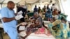 FILE - A nurse attends to mothers whose children are suffering malnutrition in a clinic set up by health authorities in collaboration with Medecins Sans Frontieres or Doctors Without Borders in Katsina State, northwest Nigeria, on July 20, 2022.