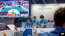 The Ukraine team of, from left, Danylo, Zakhar and Artem, compete during the 6th edition of the First Global Robotics Challenge in Geneva, Switzerland, Oct. 15, 2022.