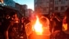 FILE - In this Sept. 21, 2022, photo taken by an individual not employed by The Associated Press and obtained by the AP outside Iran, protesters block the street during a protest over the death of a woman detained by the morality police, in downtown Tehran, Iran.