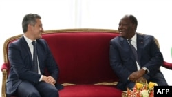 Ivory Coast president Alassane Ouattara (R) meet with French Interior Minister Gerald Darmanin (L) at the presidential palace in Abidjan on September 27, 2022. 