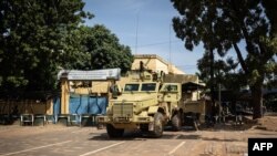 A military vehicle is seen in front of Burkina Faso's national television complex, In Ouagadougou, Oct. 1, 2022.
