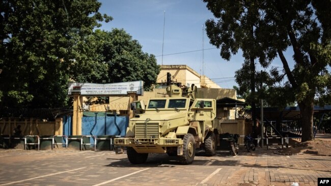 A military vehicle is seen in front of Burkina Faso's national television complex, In Ouagadougou, Oct. 1, 2022.