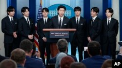 FILE - RM, center, and other K-pop supergroup BTS members speaks during the daily briefing at the White House in Washington, May 31, 2022.