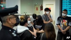 Malaysian youths rescued from human traffickers in Cambodia arrive at the Kuala Lumpur Airport Terminal in Sepang, Thursday, Oct. 6, 2022. 