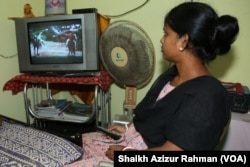 A woman watches television at an Indian home. Adults spend long hours daily, watching television at home which has weakened the social cohesion in society, many experts say.