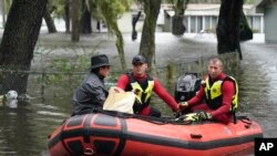 Residents in an Orlando, Fla., neighborhood are rescued due to floodwaters from Hurricane Ian, Sept. 29, 2022.