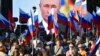 People gather in front of a large screen to celebrate the incorporation of regions of Ukraine into Russia, in Sevastopol, Crimea, Sept. 30, 2022. (AP Photo)