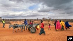 FILE - People arrive at a displacement camp on the outskirts of Dollow, Somalia, Sept. 20, 2022.