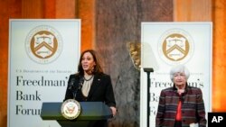 FILE - US Vice President Kamala Harris speaks during the Freedman Bank Forum as Treasury Secretary Janet Yellen looks on in Washington, Dec. 14, 2021. 