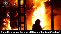 Firefighters work to put out a fire at energy infrastructure facilities damaged by Russian drone strike, as Russia's attack on Ukraine continues, in undisclosed location, Ukraine, Oct. 27, 2022.