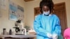 Medical lab assistant Mellon Kyomugisha, who said she was the first to examine the first confirmed Ebola victim when he came to St. Florence Clinic with malaria, takes a blood sample from a toddler at the clinic in Madudu, near Mubende, in Uganda, Sept. 28, 2022. 