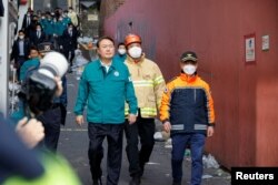 FILE - South Korean President Yoon Suk-yeol walks at the scene where many people died and were injured in a stampede during a Halloween festival in Seoul, South Korea, Oct. 30, 2022.