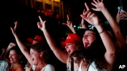 Supporters of Brazil's former President Luiz Inacio Lula da Silva celebrate partial results after polls closed in the country's presidential runoff election, in Rio de Janeiro, Oct. 30, 2022.