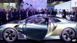 FILE: French President Emmanuel Macron views the Peugeot DS E-Tense Performance at the Paris Car Show, Oct. 17, 2022. 