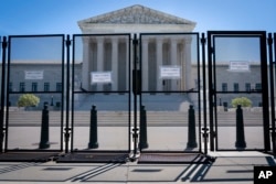 Anti-scaling fencing blocks off the stairs to the Supreme Court, May 10, 2022, in Washington, after a leaked draft of a high court opinion suggested the court was poised to overturn the landmark 1973 Roe v. Wade decision that legalized abortion nationwide
