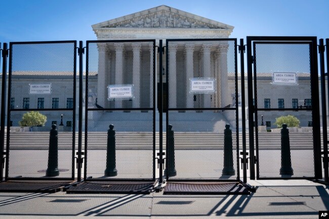 Anti-scaling fencing blocks off the stairs to the Supreme Court, May 10, 2022, in Washington, after a leaked draft of a high court opinion suggested the court was poised to overturn the landmark 1973 Roe v. Wade decision that legalized abortion nationwide