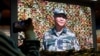 资料照：北京的中国军事博物馆内的大屏幕显示中国领导人习近平视察军队。（2022年10月8日）