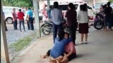 In this image taken from video, a woman is comforted outside the site of an attack at a childcare center, Thursday, Oct. 6, 2022, in the town of Nongbua Lamphu, north eastern Thailand. (Mungkorn Sriboonreung Rescue Group via AP)
