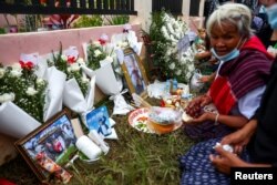 Victims' families gather during a religious ceremony to call back victims' souls outside the daycare centre, which was the scene of a mass shooting in the town of Uthai Sawan, in the province of Nong Bua Lam Phu, Thailand, Oct. 9, 2022.