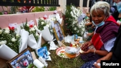 Victims' families gather during a religious ceremony to call back victims' souls outside the daycare center in the town of Uthai Sawan, in the province of Nong Bua Lam Phu, Thailand, Oct. 9, 2022. 