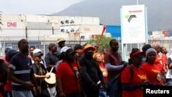 Transnet workers walk past ship containers in Cape Town amid nationwide strikes, October 11, 2022