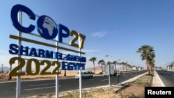 View of a COP27 sign on the road leading to the conference area in Egypt's Red Sea resort of Sharm el-Sheikh town as the city prepares to host the COP27 summit next month, in Sharm el-Sheikh, Egypt, Oct. 20, 2022.