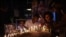 FILE - People hold a candlelight vigil for the victims and injured demonstrators during anti-government protests, in Colombo, July 16, 2022.