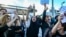 FILE - People shout slogans during a protest against the death of Iranian Mahsa Amini, in Istanbul, Turkey, Oct. 2, 2022. 