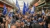 Former Israeli Prime Minister and head of Likud party Benjamin Netanyahu, center, surrounded by security and his supporters, visits at Hatikva Market in Tel Aviv, Israel, Oct. 28, 2022, during his campaign ahead of the country's election. 