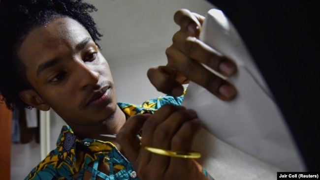 Esteban Sinisterra works on a dress on a mannequin in his studio in Cali, Colombia September 7, 2022.