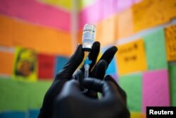 FILE - Dr. Mayank Amin draws the Moderna coronavirus booster vaccine at Skippack Pharmacy in Schwenksville, Pennsylvania, Sept. 8, 2022.