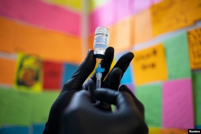 FILE - Dr. Mayank Amin draws the Moderna coronavirus booster vaccine at Skippack Pharmacy in Schwenksville, Pennsylvania, Sept. 8, 2022.