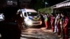 An ambulance carrying victims' coffins arrives at a hospital morgue in Udon Thani, Thailand, Oct. 6, 2022, following a mass shooting at a child care center by a former police officer. At least 38 people, including 24 children, were killed. 