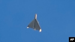 A drone is seen in the sky seconds before it fired on buildings in Kyiv, Oct. 17, 2022. 