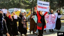 Women carry placards and chant slogans during a protest they call "Stop Hazara Genocide," a day after a deadly suicide bomb attack at a learning center, in Kabul, Afghanistan, Oct. 1, 2022.