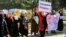 Women carry placards and chant slogans during a protest they call "Stop Hazara Genocide," a day after a deadly suicide bomb attack at a learning center, in Kabul, Afghanistan, Oct. 1, 2022.