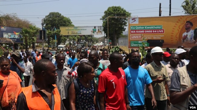 FILE - Protesters march against the rising cost of living and poor governance, in Blantyre, Malawi, Oct. 27, 2022.