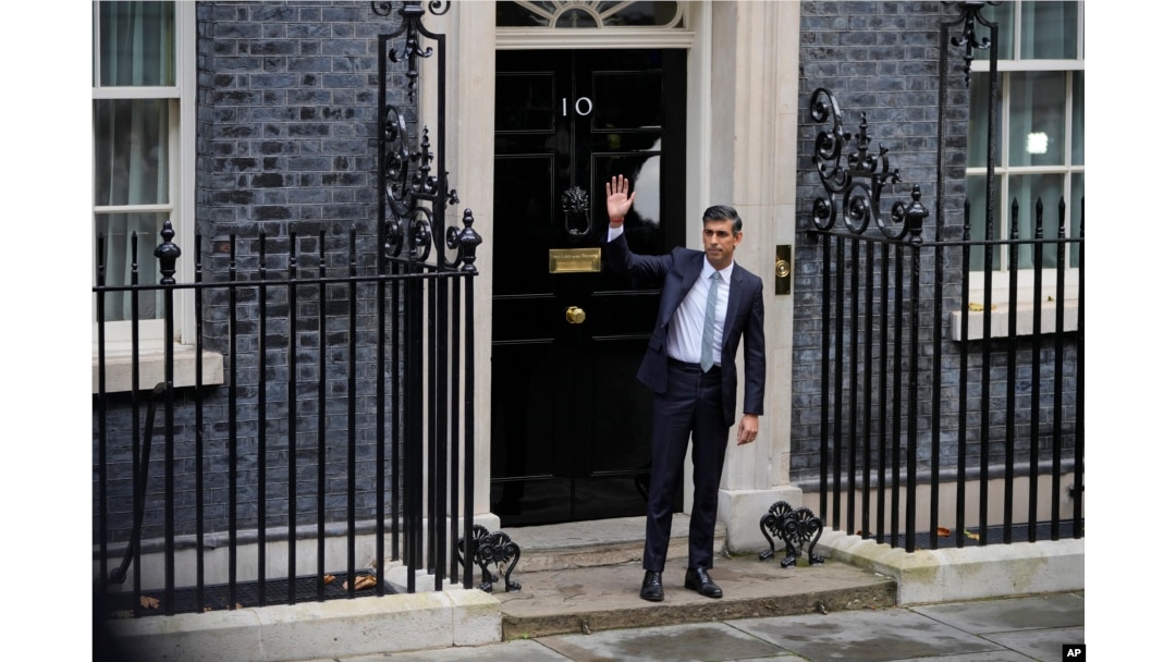 New British Prime Minister Rishi Sunak waves after arriving at Downing Street in London, Oct. 25, 2022, after returning from Buckingham Palace where he was formally appointed to the post by Britain's King Charles III.