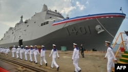 Taiwanese navy soldiers walk by a Yushan-class landing platform dock during in Kaohsiung on Sept. 30, 2022. 