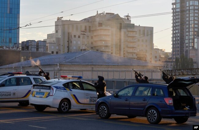 Ukrainian soldiers shoot a drone that appears in the sky seconds before it fired on buildings in Kyiv, Ukraine, Monday, Oct. 17, 2022. (AP Photo/Vadym Sarakhan)