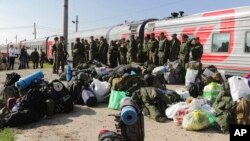 Russian recruits gather to take a train at a railway station in Prudboi, Volgograd region of Russia, Sept. 29, 2022.