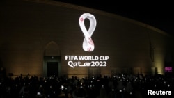 FILE - The tournament's official logo for the 2022 Qatar World Cup is seen on the wall of an amphitheater, in Doha, Qatar, Sept. 3, 2019.