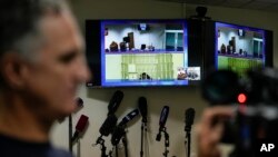 WNBA star and two-time Olympic gold medalist Brittney Griner is seen on the bottom part of a TV screen as she waits to appear in a video link provided by the Russian Federal Penitentiary Service a courtroom prior to a hearing at Moscow Regional Court.
