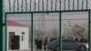 FILE - Residents line up inside the Artux City Vocational Skills Education Training Service Center, which was revealed by leaked documents to be a forced indoctrination camp at the Kunshan Industrial Park in Artux in western China's Xinjiang region, Dec. 3, 2018.