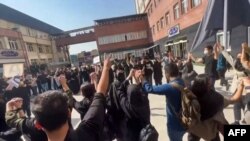 This still from a UGC video made available on Oct. 15, 2022, shows Iranian students chanting "Freedom" as they rally at Tehran's University of Science and Culture.