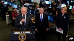 President Joe Biden speaks about Hurricane Ian during a visit to Federal Emergency Management Agency (FEMA) headquarters, in Washington, Sept. 29, 2022, as FEMA Administrator Deanne Criswell, right, and Homeland Security Secretary Alejandro Mayorkas look on.