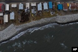 Small waves crash into reinforced seawalls in Shishmaref, Alaska, Tuesday, Oct. 4, 2022.